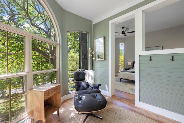 sunroom / solarium with lofted ceiling and ceiling fan