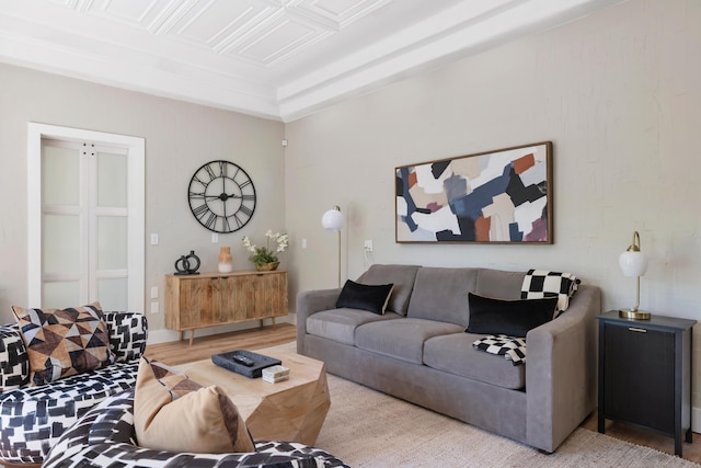 living room featuring an ornate ceiling and wood finished floors