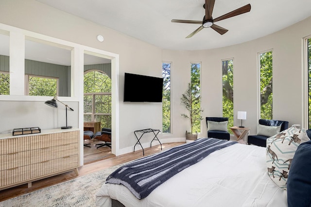 bedroom with baseboards and wood finished floors