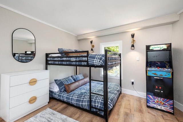 bedroom with baseboards and wood finished floors