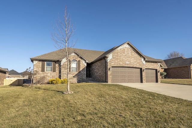 view of front of property featuring a garage, driveway, brick siding, and a front lawn