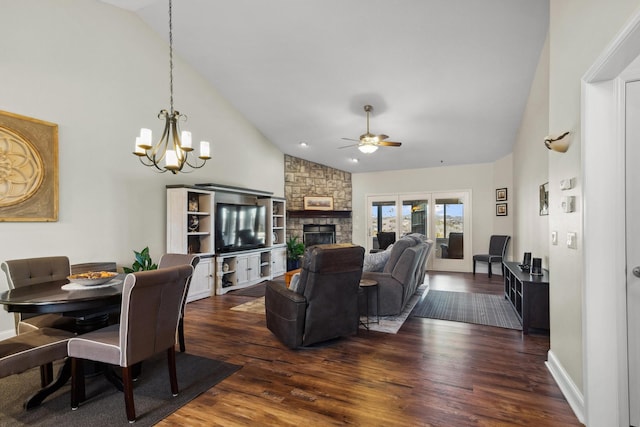 living area with high vaulted ceiling, dark wood-style flooring, a fireplace, and ceiling fan with notable chandelier