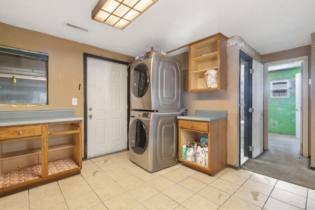 washroom featuring light tile patterned flooring, light carpet, laundry area, visible vents, and stacked washing maching and dryer