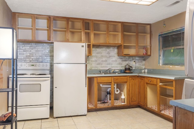 kitchen with white appliances, decorative backsplash, brown cabinets, open shelves, and a sink