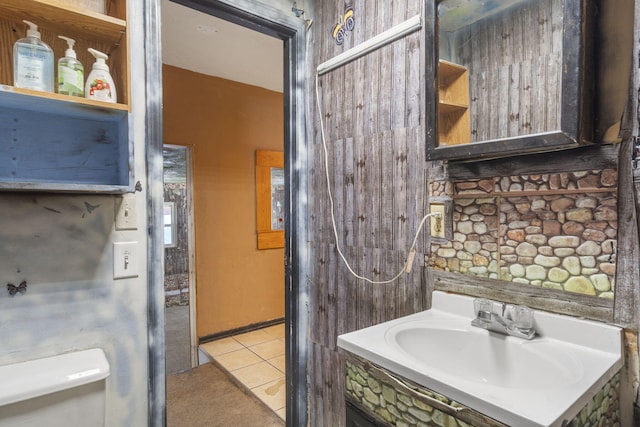 bathroom featuring tile patterned flooring, vanity, and toilet