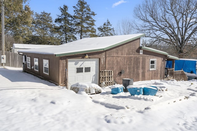 view of snowy exterior with fence