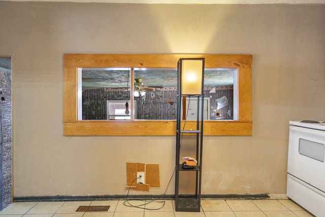 interior details featuring white range with electric stovetop and baseboards