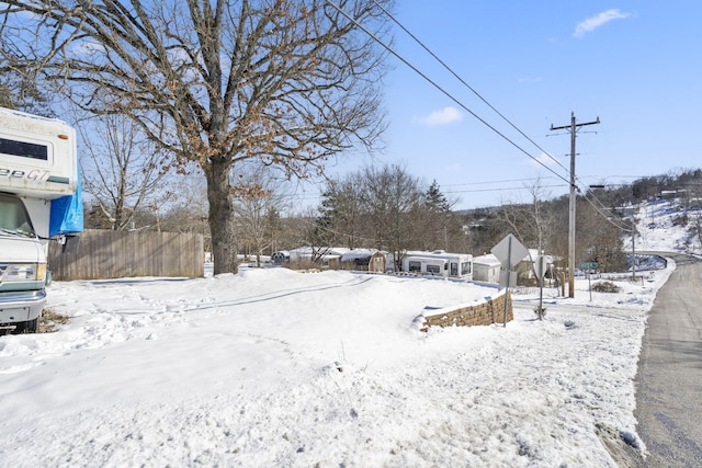 snowy yard with fence