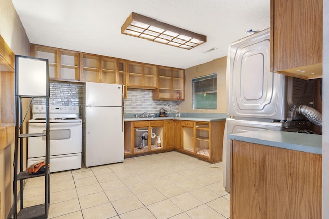 kitchen featuring white appliances, light countertops, backsplash, open shelves, and brown cabinetry