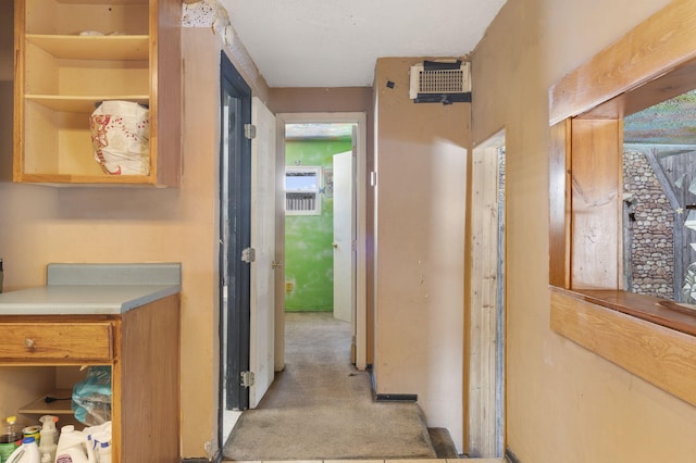 hallway with light carpet and visible vents