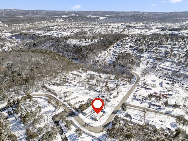 snowy aerial view with a mountain view