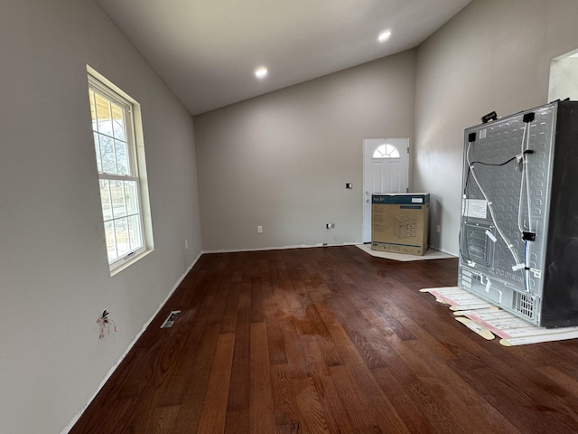 interior space featuring high vaulted ceiling, recessed lighting, visible vents, and wood finished floors