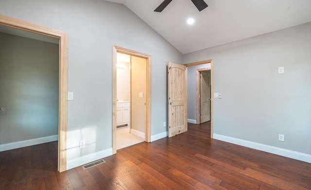 unfurnished bedroom with wood finished floors, connected bathroom, vaulted ceiling, baseboards, and visible vents