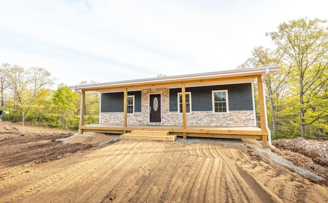 view of front of house with a porch and stone siding