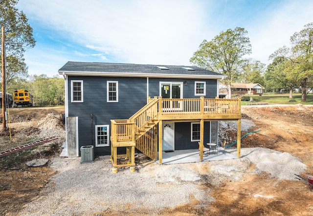 back of house featuring central AC unit, a deck, a patio area, and stairs