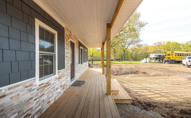 wooden terrace featuring covered porch