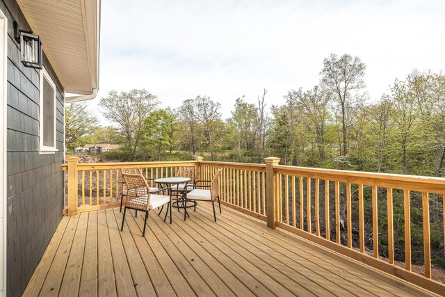 wooden deck featuring outdoor dining area