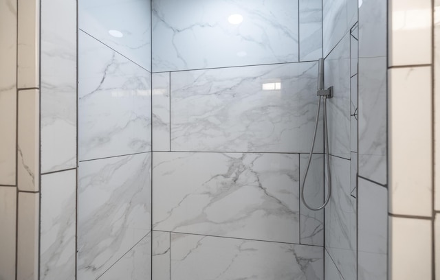 bathroom with a marble finish shower