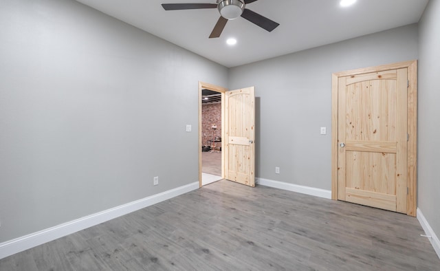 unfurnished bedroom featuring recessed lighting, a ceiling fan, wood finished floors, and baseboards