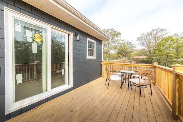 wooden terrace with outdoor dining space