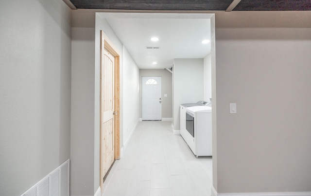 hallway with visible vents, separate washer and dryer, recessed lighting, and baseboards
