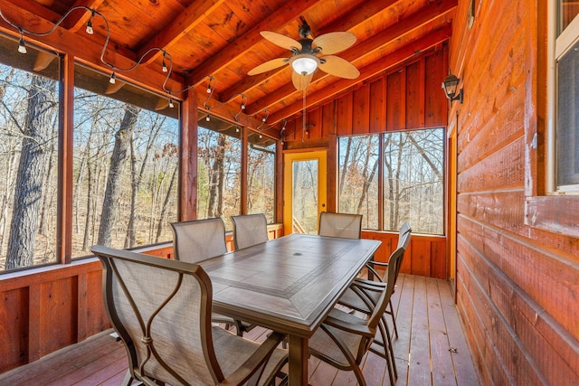 sunroom featuring vaulted ceiling with beams, wooden ceiling, and ceiling fan