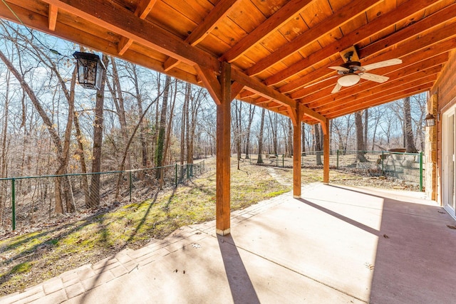 view of patio featuring ceiling fan and fence