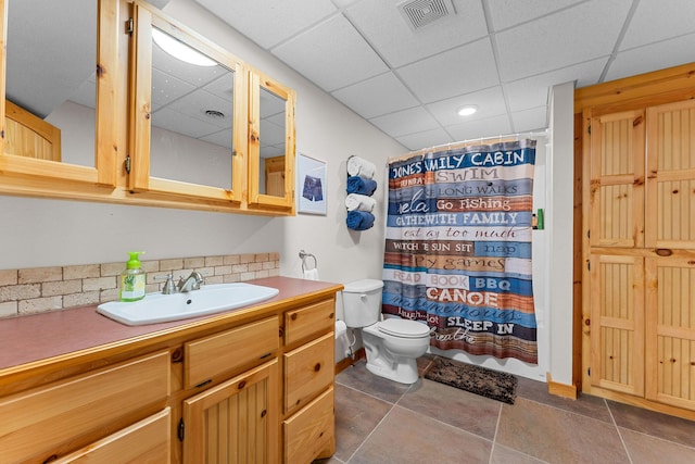 full bathroom featuring a paneled ceiling, visible vents, toilet, vanity, and a shower with curtain