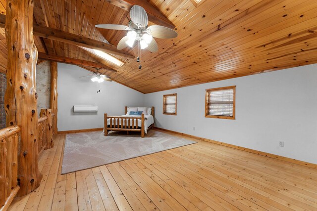 unfurnished bedroom featuring wood ceiling, lofted ceiling with skylight, hardwood / wood-style flooring, and baseboards