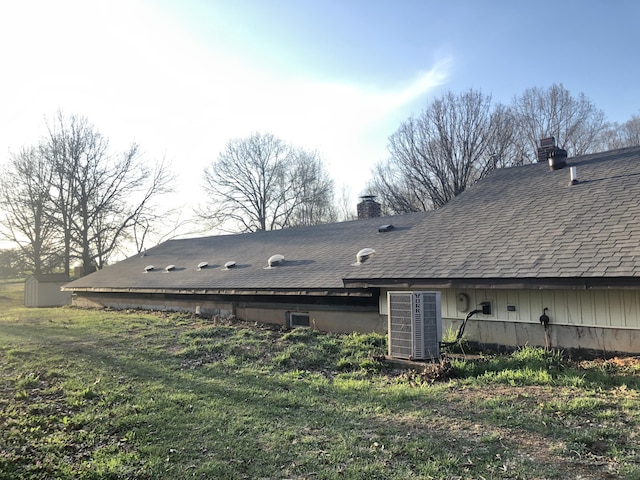 3894 Girlstown Rd, Mountain Grove, MO 65711 - back of property with a chimney, a storage unit, a shingled roof, and an outdoor structure
