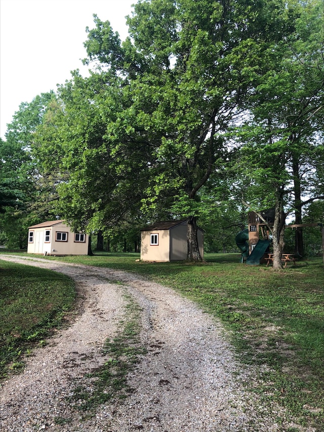 3894 Girlstown Rd, Mountain Grove, MO 65711 - view of front facade with an outdoor structure, a storage shed, and driveway