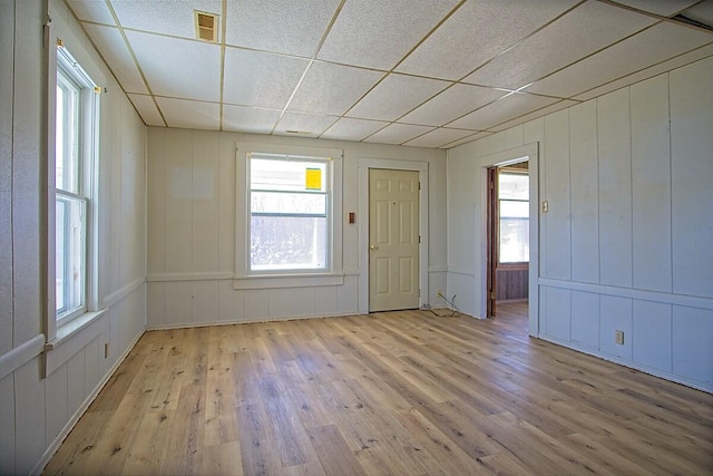 interior space featuring visible vents, wood finished floors, and a paneled ceiling