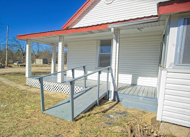 exterior space with a porch and metal roof