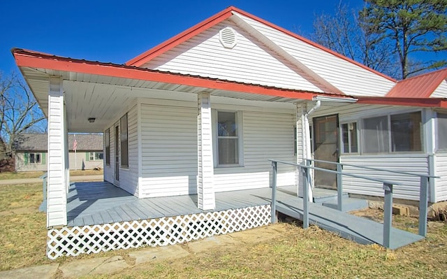 view of property exterior featuring metal roof and a yard