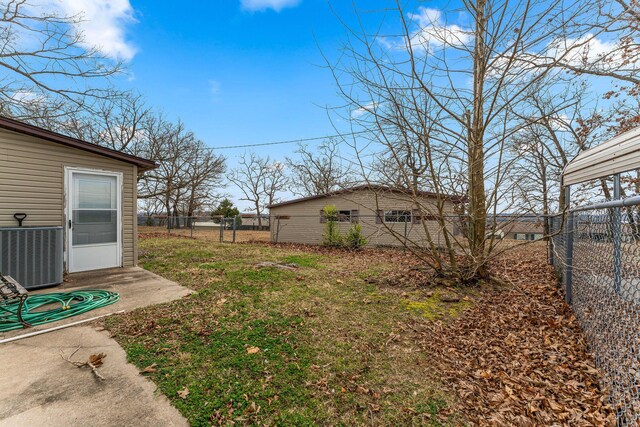 view of yard featuring fence and central AC unit