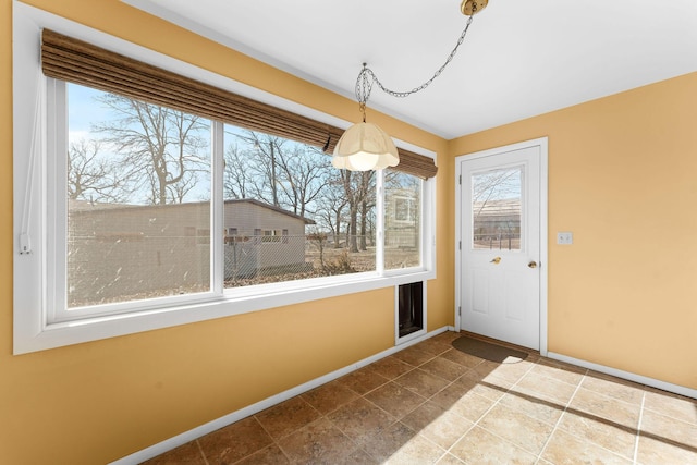 doorway to outside with baseboards