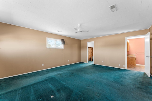 carpeted spare room featuring baseboards, visible vents, and a ceiling fan