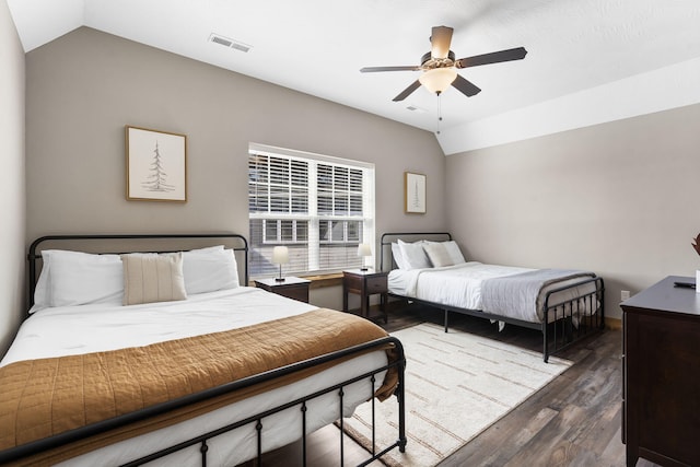 bedroom featuring vaulted ceiling, wood finished floors, visible vents, and a ceiling fan