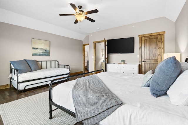 bedroom featuring lofted ceiling, baseboards, a ceiling fan, and wood finished floors