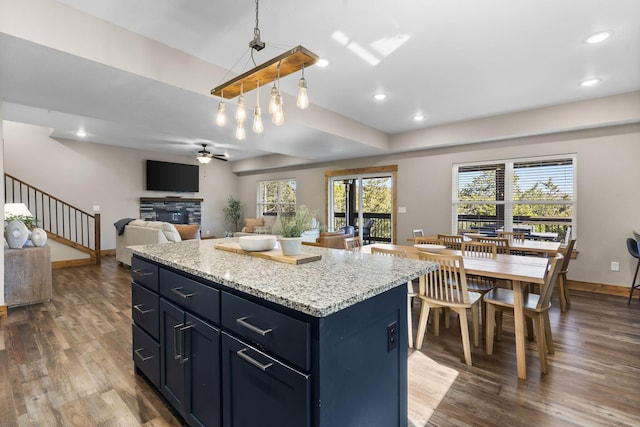 kitchen featuring recessed lighting, wood finished floors, and a center island