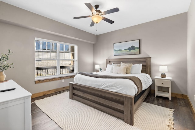 bedroom featuring ceiling fan, baseboards, and wood finished floors