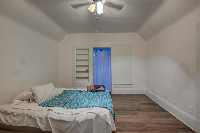 bedroom with ceiling fan, baseboards, vaulted ceiling, and wood finished floors