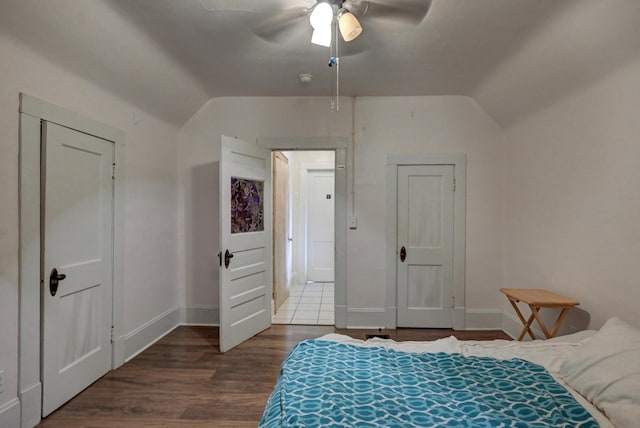 bedroom featuring lofted ceiling, a ceiling fan, baseboards, and wood finished floors