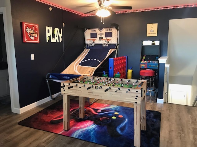 playroom with ceiling fan, baseboards, and wood finished floors