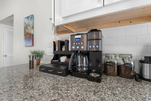 kitchen with stone counters and backsplash