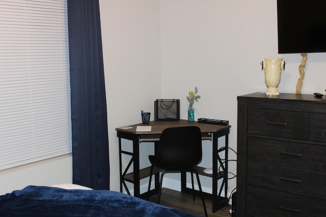 bedroom featuring baseboards and wood finished floors