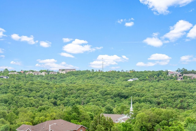 birds eye view of property featuring a wooded view