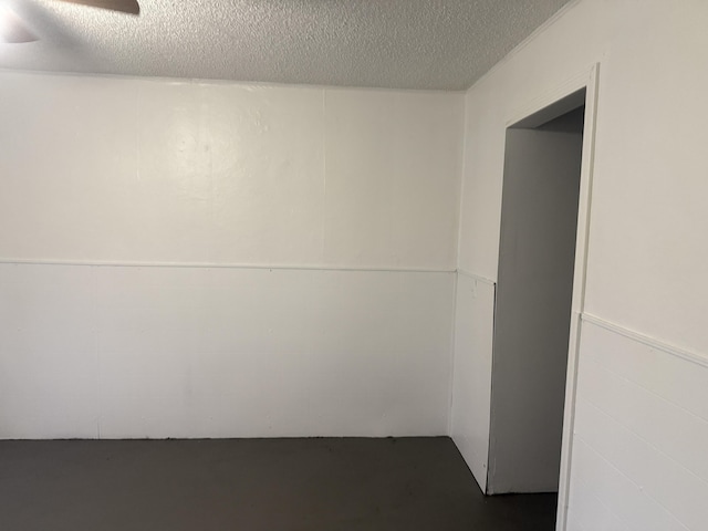 empty room featuring concrete floors and a textured ceiling