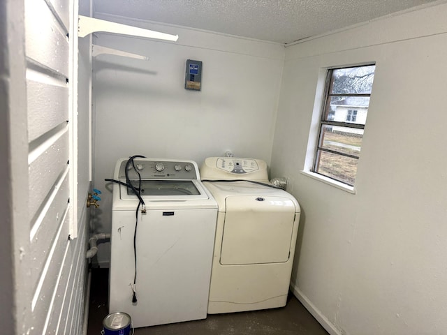 laundry room with washing machine and dryer, laundry area, and a textured ceiling