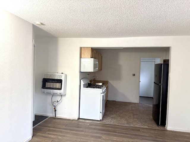 washroom with a sink, a textured ceiling, wood finished floors, and heating unit